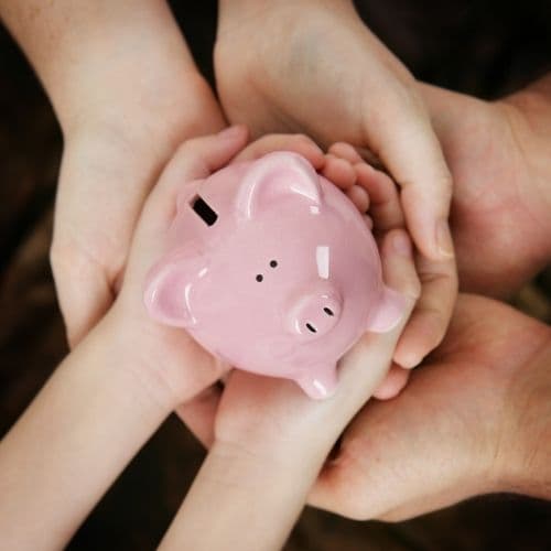 Piggy bank being held by hands
